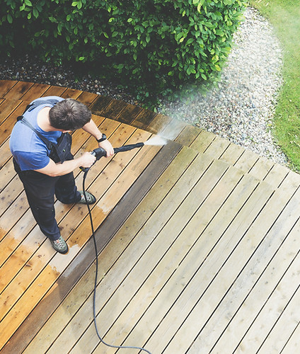 Clearwater pressure washing technician cleaning a residential driveway.