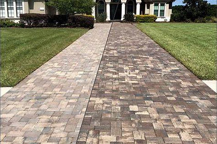 Before and after picture of a driveway getting pavers sealed in Clearwater, FL